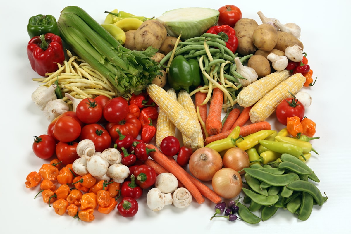 Nutritious heart-healthy foods and fresh vegetables on a wooden table